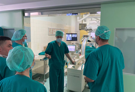 Josip Roca providing clinical application training on a C-arm system with operating-room staff in 2018